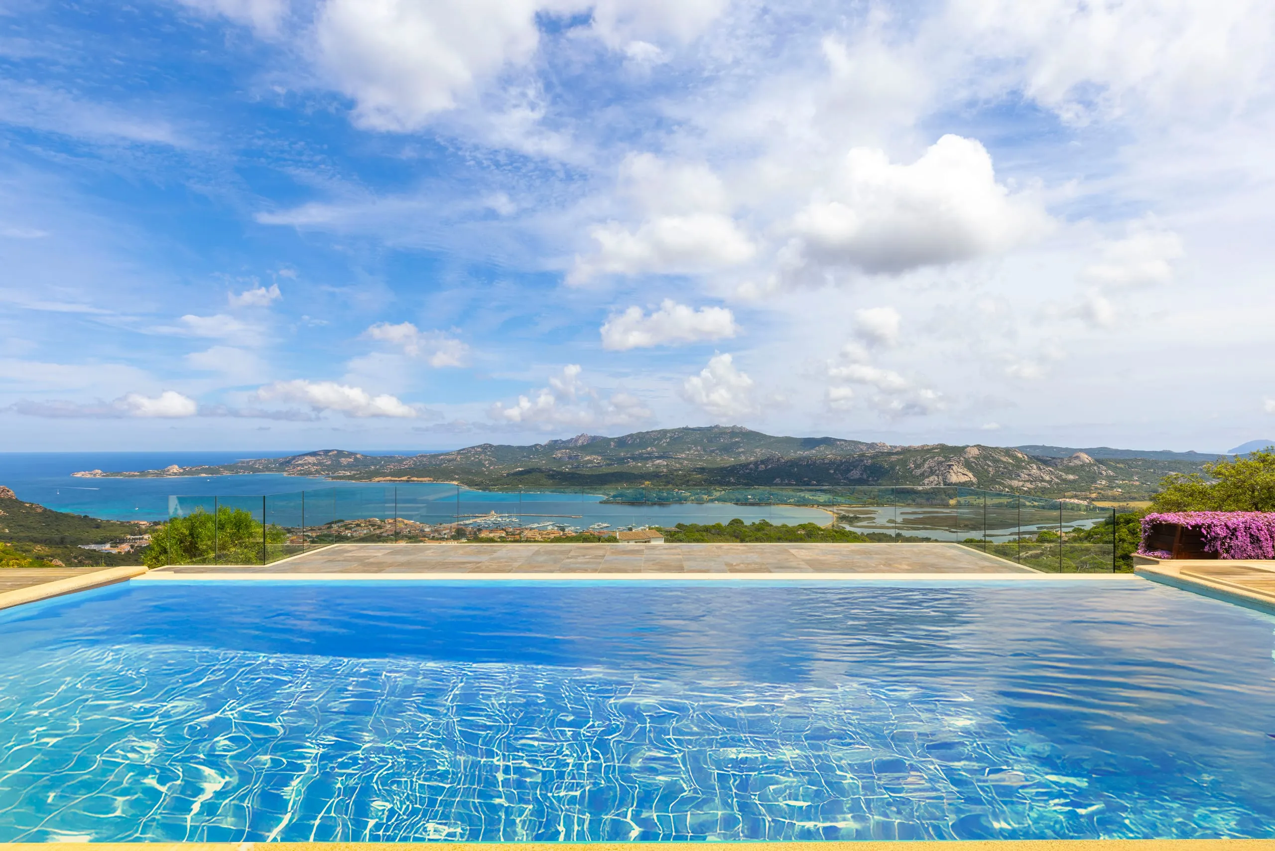 Angolatura obliqua del parapetto in vetro con fascione alluminio late RAL 9005 della villa a Porto Cervo (SS)